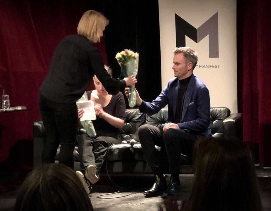 Mansdal mottar blomster etter samtale om sin nye bok.