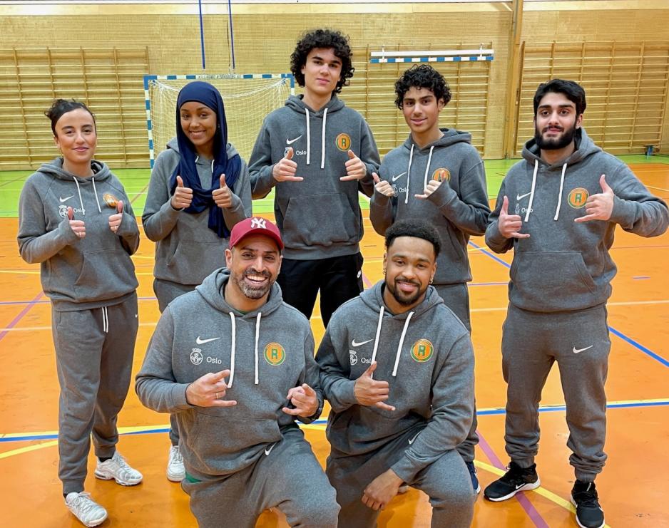 Adnan Naeem st&aring;r sammen med flere aktivitetsledere i ten&aring;rene inne i Roms&aring;shallen.