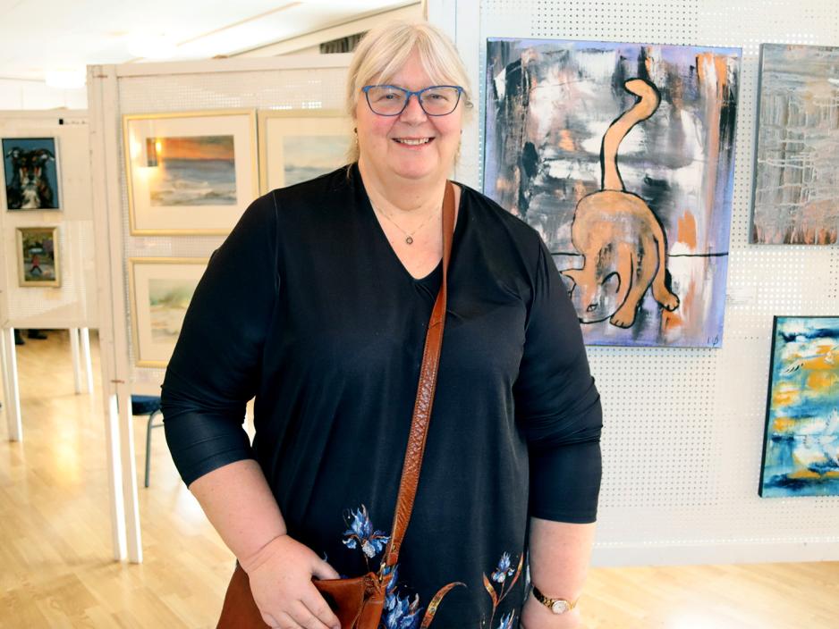 Irene &Oslash;stenseth foran kunstutstilling.