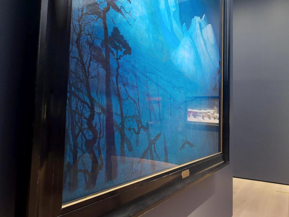 N&aelig;rbilde av et maleri med glass over. I glasset ser man kunsten p&aring; andre siden av rommet.