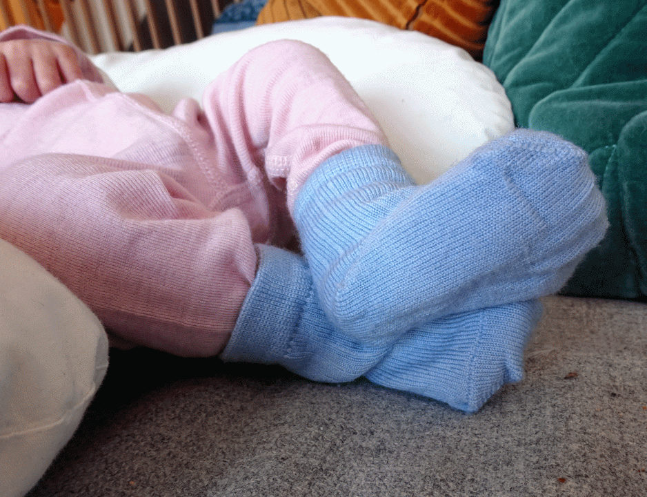 Eit par med babyf&oslash;ter med lysebl&aring; sokkar. 