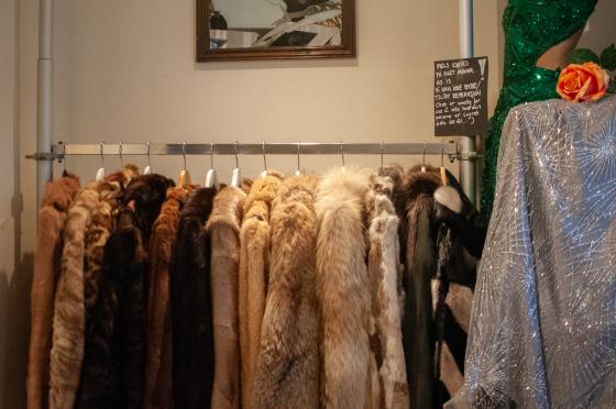 en rekke med pelsk&aring;per som henger i en butikk, ved siden av st&aring;r er det et skilt hvor butikken advarer at det ikke er bytterett p&aring; k&aring;pene. 