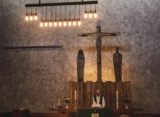 Presten i Sinsen kirke st&aring;r bak alteret.