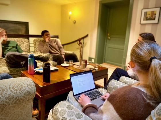 URO-ambassad&oslash;rer sitter i en sofagruppe og skriver p&aring; en pc. 