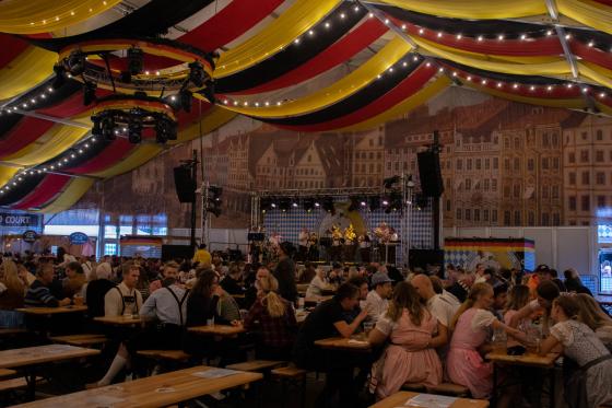 Inn i teltet til oktoberfest. Vi ser flere personer som har det g&oslash;y og h&oslash;rer p&aring; de tyske sangene i bakgrunnen.