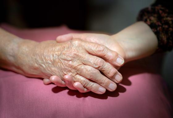 N&aelig;rbilde av datter og pappa som sitter og holder hender