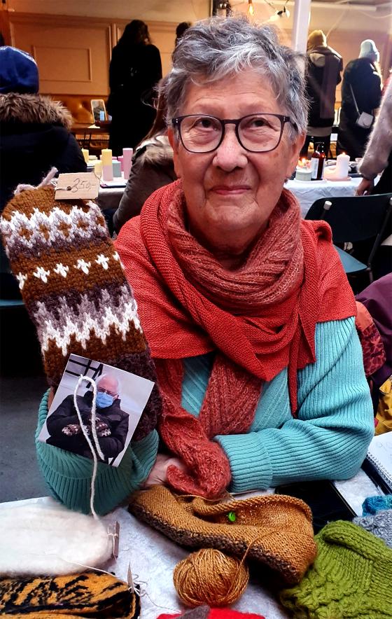 Solrunn Husum, en av selgerne ved S&oslash;ndagsmarkedet i Ingensgate. Her viser hun frem de hjemmestrikkede Bernie Sanders-vottene. 